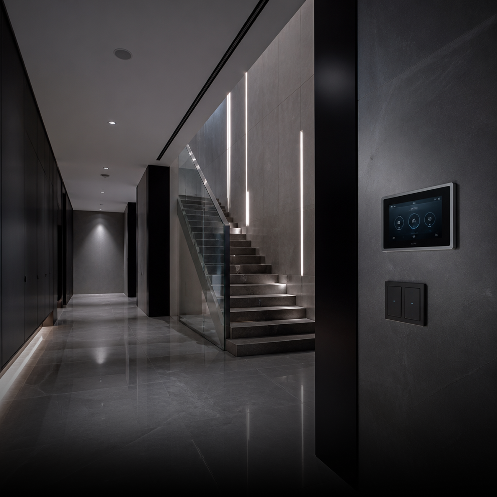 Modern hallway with marble flooring, minimalist staircase, vertical wall lights, and wall-mounted touchscreen panel.